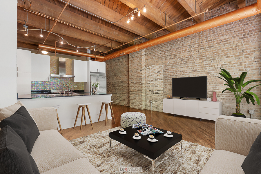 1040 West Adams Street, Unit 247 Chicago, IL 60607 - Photo 6 of 20 a living room with furniture a flat screen tv and a fireplace