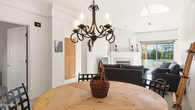 a living room with furniture a fireplace and a floor to ceiling window