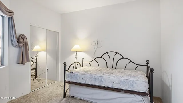 a bedroom with a bed and a window