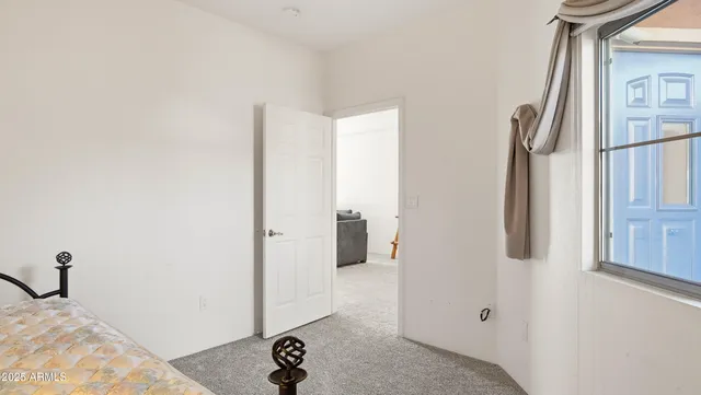 a bedroom with a bed and a table in it