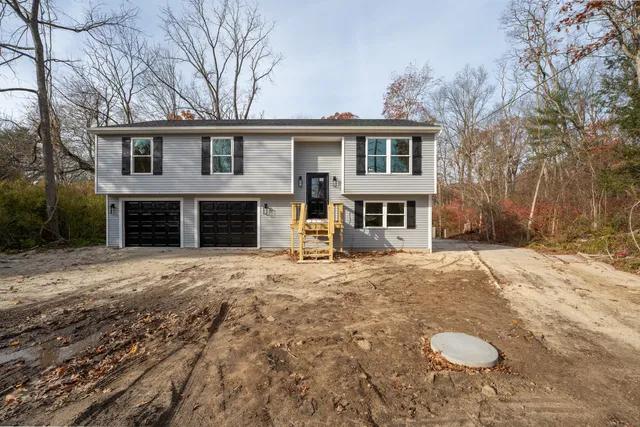 a front view of a house with a yard