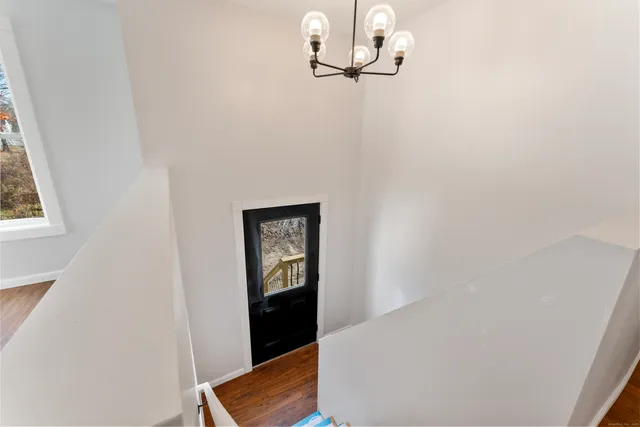 a view of hallway with wooden floor