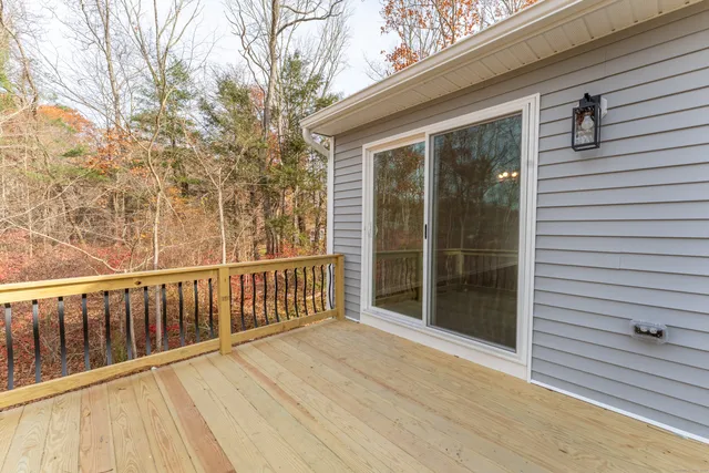 a view of balcony with wooden floor and fence