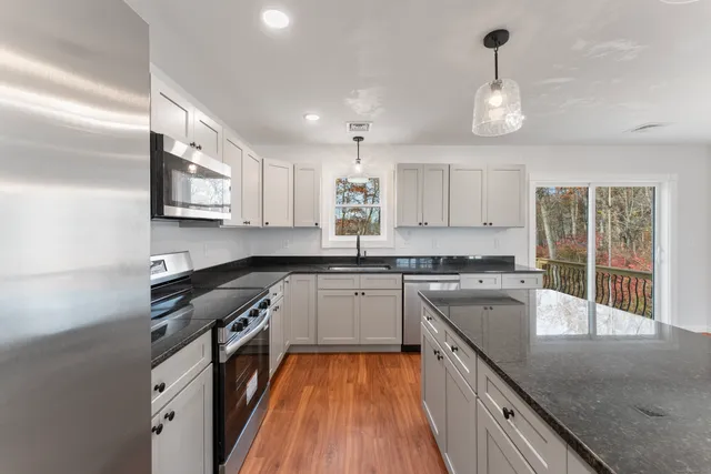 a kitchen with a sink stove and cabinets