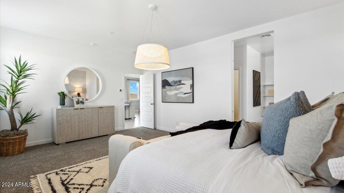 1126 South Mulberry Street Florence, AZ 85132 - Photo 17 of 21 a bedroom with a bed and a potted plant