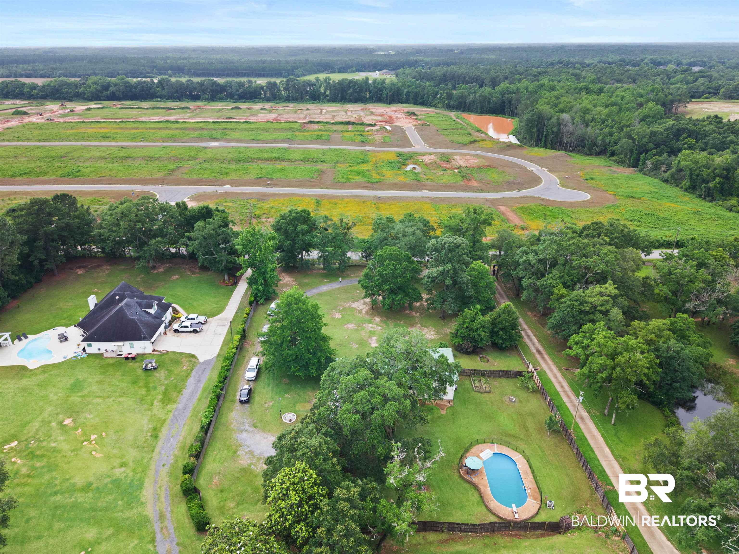 10420 Johnson Road South Mobile, AL 36695 - Photo 70 of 75 Expansive property featuring two distinct residences, two in-ground swimming pools, mature trees, and a private pond