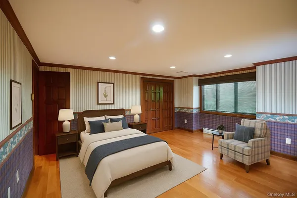 a bedroom with furniture and a large window