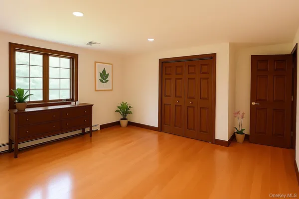an empty room with windows and closet