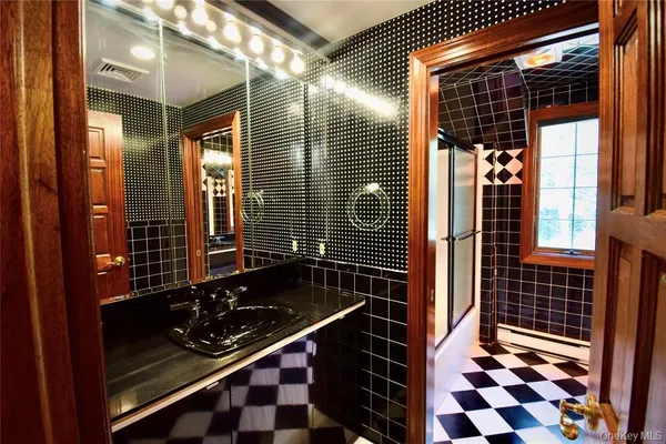 a bathroom with a bathtub and shower