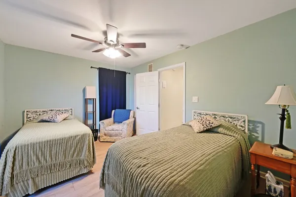 a bedroom with two beds and a chandelier