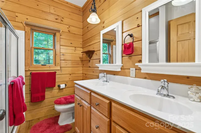 a bathroom with a sink vanity mirror and toilet