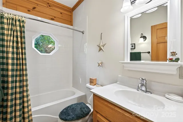 a bathroom with a sink a bathtub and a window
