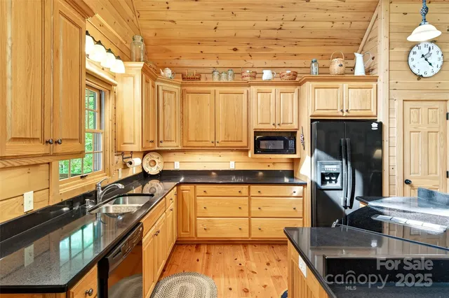 a kitchen with stainless steel appliances a stove a sink and a refrigerator