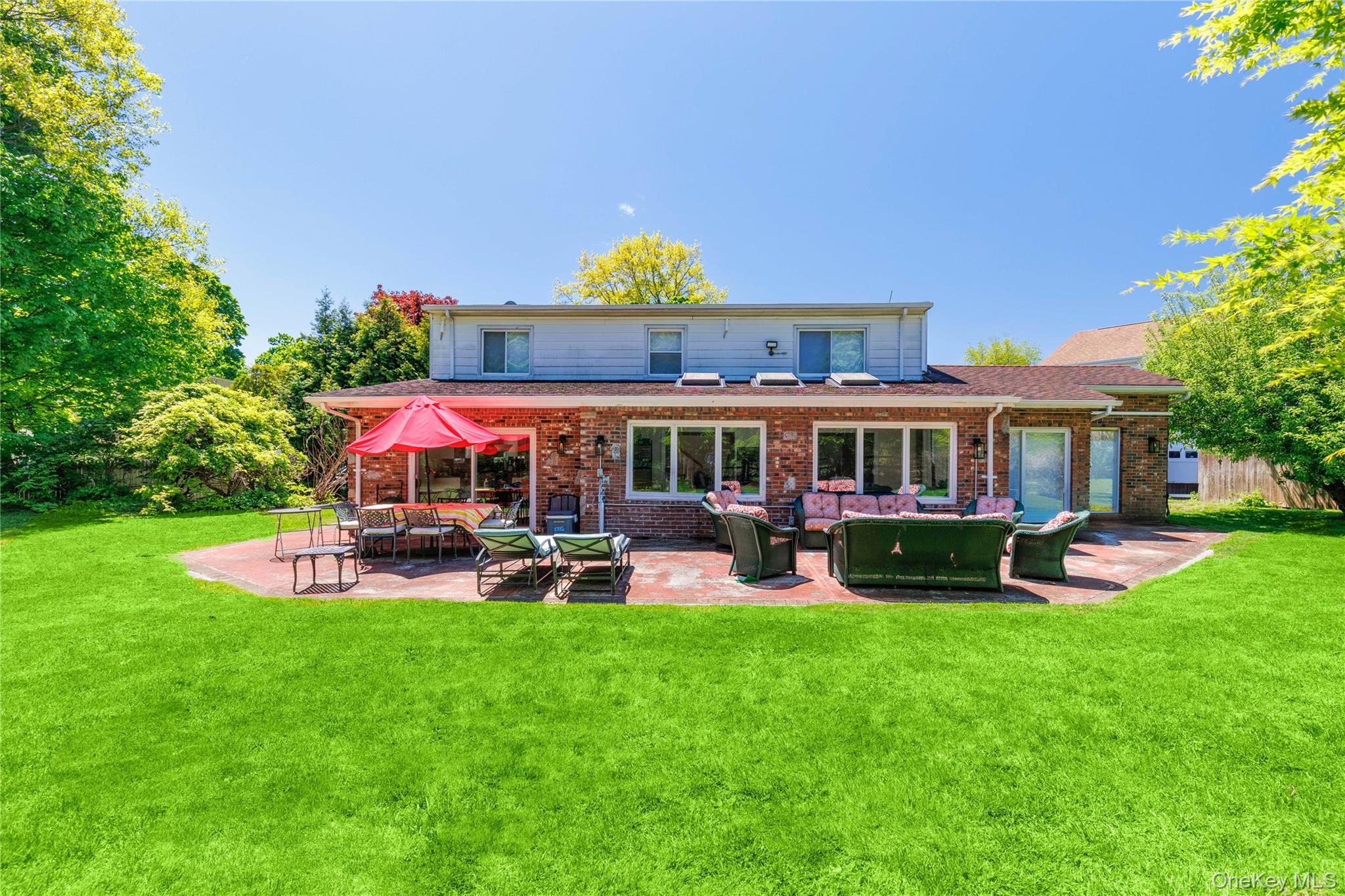 10 Bell Place Rye Brook, NY 10573 - Photo 3 of 25 Back View with Stone Patio - Glorious Grounds