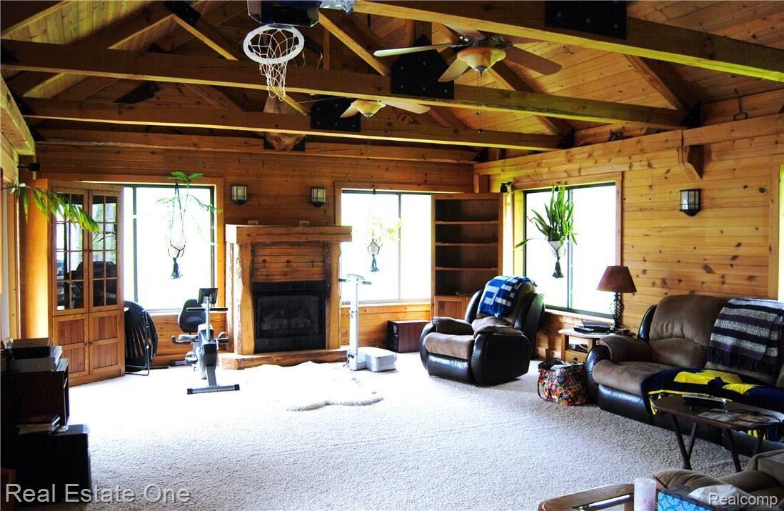 4704 Baldwin Road Metamora, MI 48455 - Photo 7 of 29 Great Room with knotty pine planks and exposed beams, walkout access to the deck and backyard