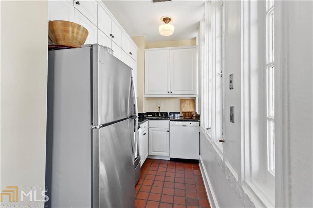 1 South Prado Northeast, Unit 5 Atlanta, GA 30309 - Photo 11 of 33 a kitchen with white cabinets and refrigerator
