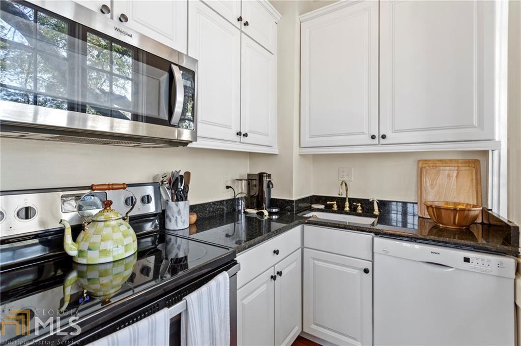 1 South Prado Northeast, Unit 5 Atlanta, GA 30309 - Photo 12 of 33 a kitchen with stainless steel appliances granite countertop a sink stove and cabinets