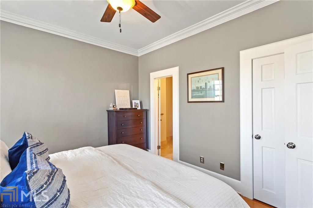 1 South Prado Northeast, Unit 5 Atlanta, GA 30309 - Photo 17 of 33 a bedroom with a bed and a chandelier