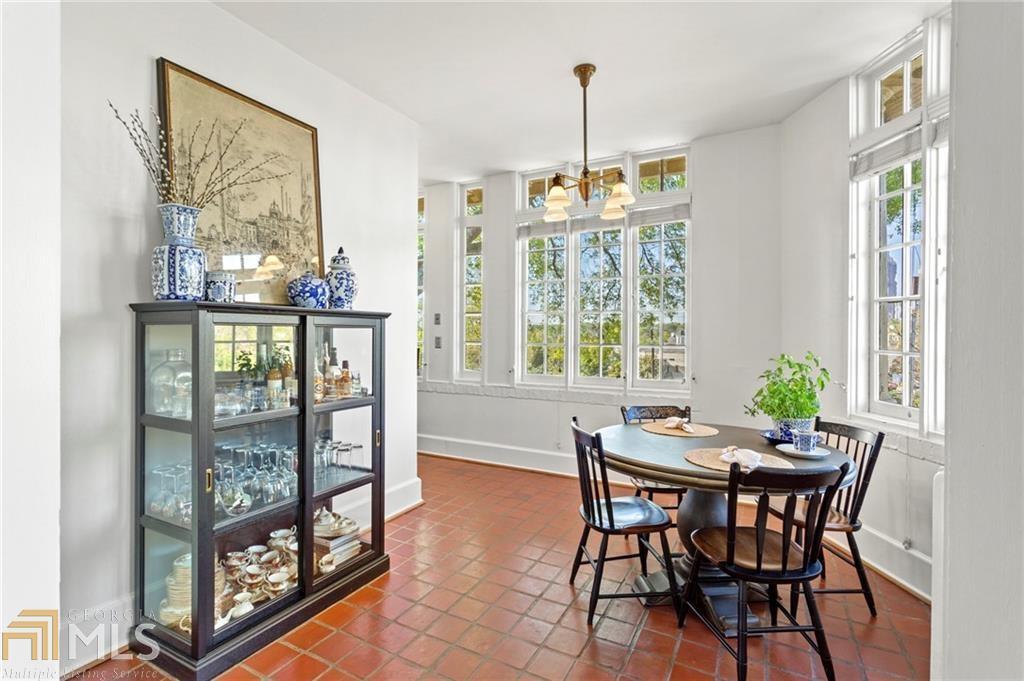 1 South Prado Northeast, Unit 5 Atlanta, GA 30309 - Photo 8 of 33 a view of a dining room with furniture large windows and wooden floor