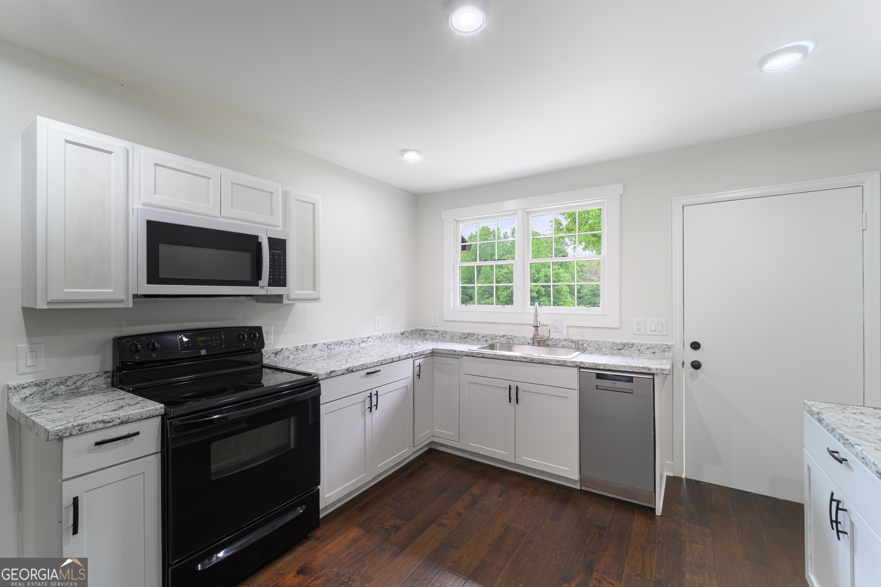 418 Lamb Road Moreland, GA 30259 - Photo 6 of 32 a kitchen with a sink stove and microwave