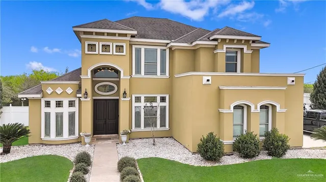 a front view of a house with garden
