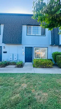 a front view of a house with a yard and a garage