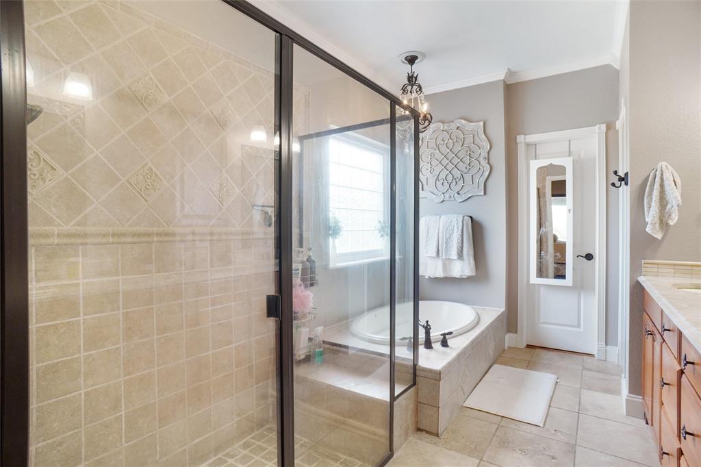 13340 John Day Road Haslet, TX 76052 - Photo 16 of 30 a bathroom with a glass shower door and a bathtub