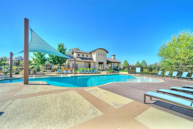 a view of swimming pool with a yard and sitting area
