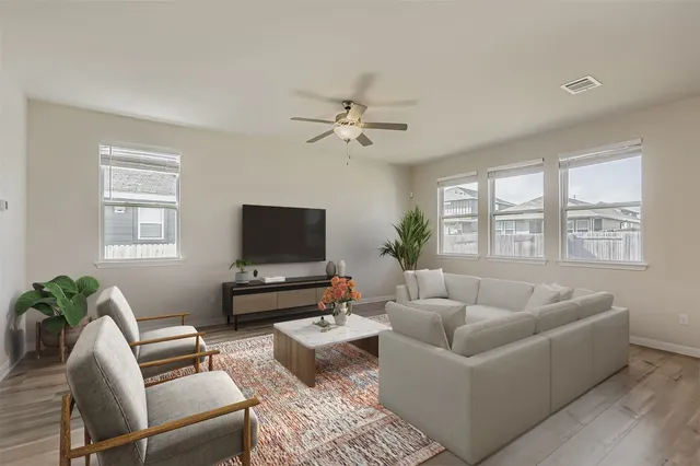 a living room with furniture and a flat screen tv
