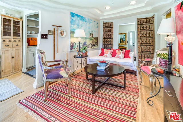 a living room with furniture a rug and a flat screen tv