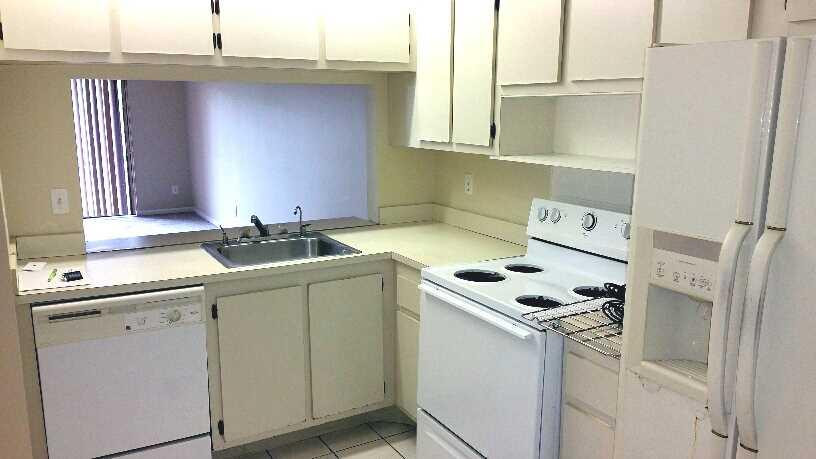 5282 Gate Lake Road, Unit 5282 Tamarac, FL 33319 - Photo 2 of 8 a utility room with cabinets washer and dryer