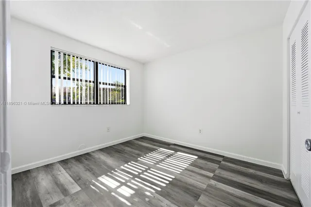 a view of wooden floor and windows in a room