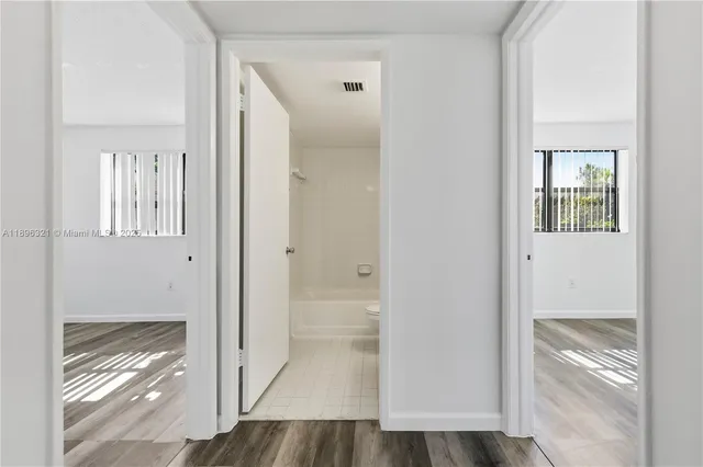 a view of a bathroom from the hallway