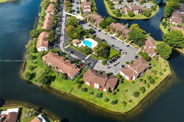 an aerial view of a residential houses with yard