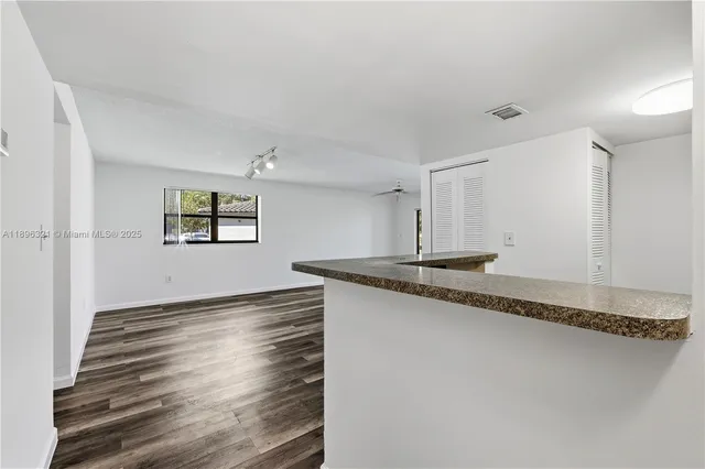 a kitchen with granite countertop a sink and a stove