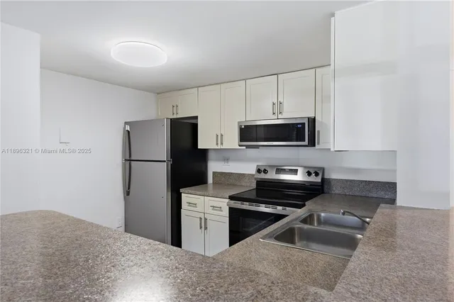 a kitchen with a refrigerator stove and microwave