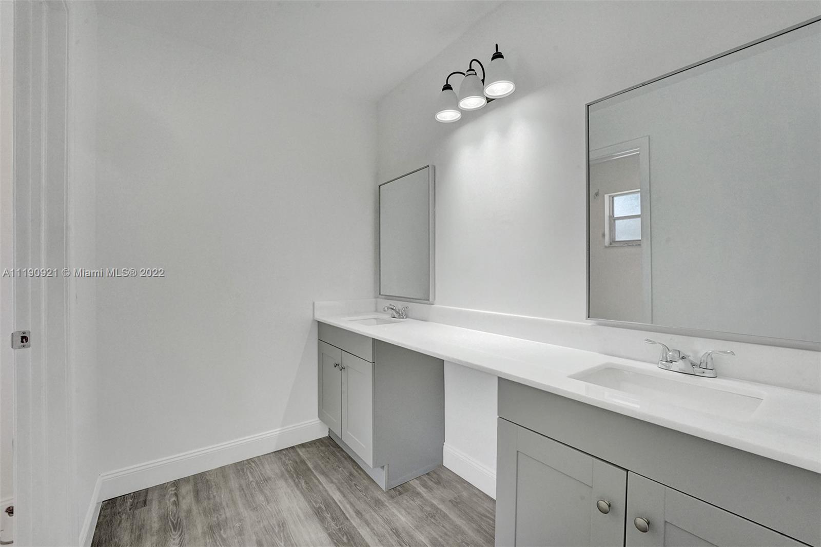 23098 Southwest 55th Avenue Boca Raton, FL 33433 - Photo 30 of 49 a bathroom with a sink and a mirror