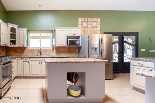 480 Camino Ramanote Rio Rico, AZ 85648 - Photo 9 of 43 Large kitchen enhanced with skylights and convenient center island, stainless appliances and custom ironwork doors to covered back patio.