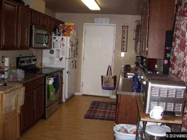 685 Nancy Circle Reno, NV 89503 - Photo 5 of 9 a kitchen with stainless steel appliances granite countertop a refrigerator and a stove top oven