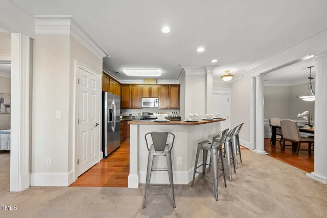 a large kitchen with a table and chairs