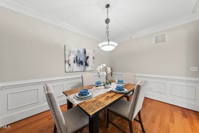 a view of a dining room with furniture wooden floor and chandelier