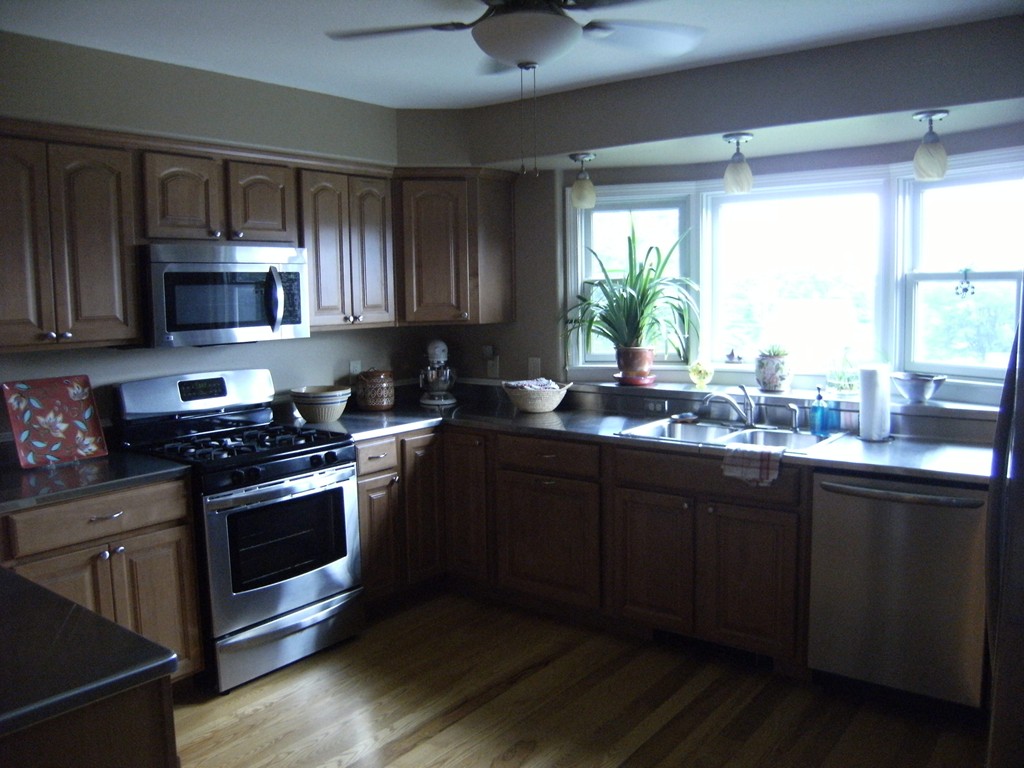 74 Goss Hill Road Huntington, MA 01050 - Photo 6 of 24 a kitchen with stainless steel appliances wooden cabinets a stove a sink and a window