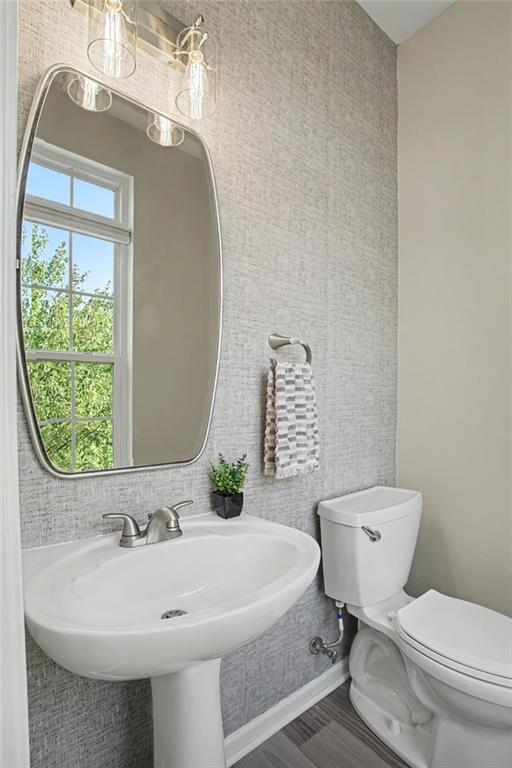 361 Wealdstone Road Cranberry Township, PA 16066 - Photo 14 of 46 Powder room on main floor has striking wallpaper and newer LVP flooring that flows throughout the main level.