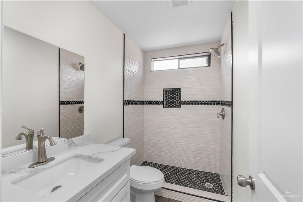 211 Gastel Circle, Unit 2 Edinburg, TX 78539 - Photo 12 of 22 a bathroom with a sink a toilet and shower