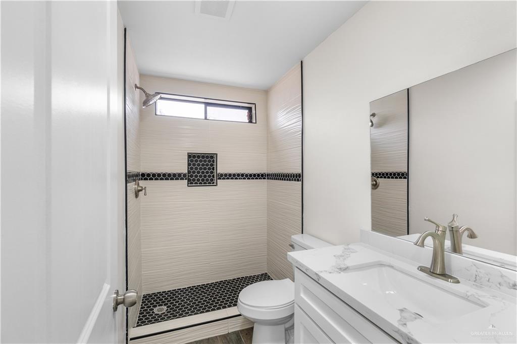 211 Gastel Circle, Unit 2 Edinburg, TX 78539 - Photo 15 of 22 a bathroom with a granite countertop sink toilet and shower