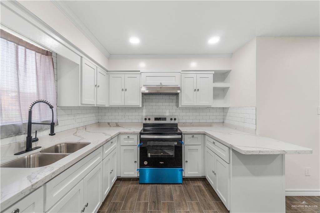 211 Gastel Circle, Unit 2 Edinburg, TX 78539 - Photo 9 of 22 a kitchen with white cabinets stainless steel appliances and sink