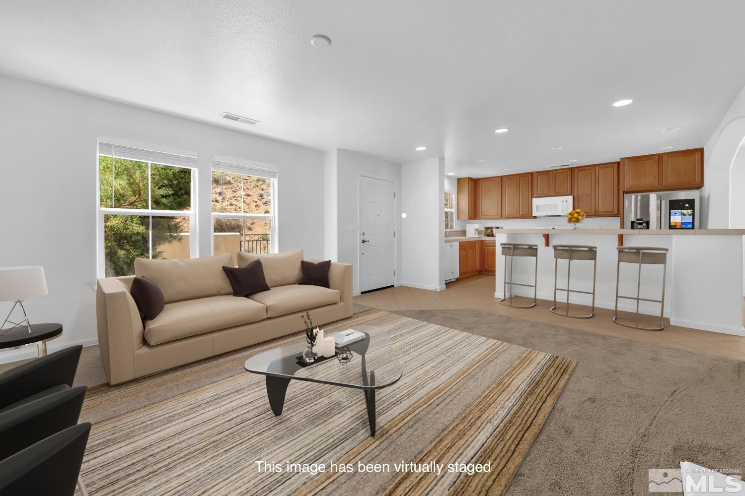 7696 Stone Bluff Way Reno, NV 89523 - Photo 3 of 40 a living room with furniture and a large window