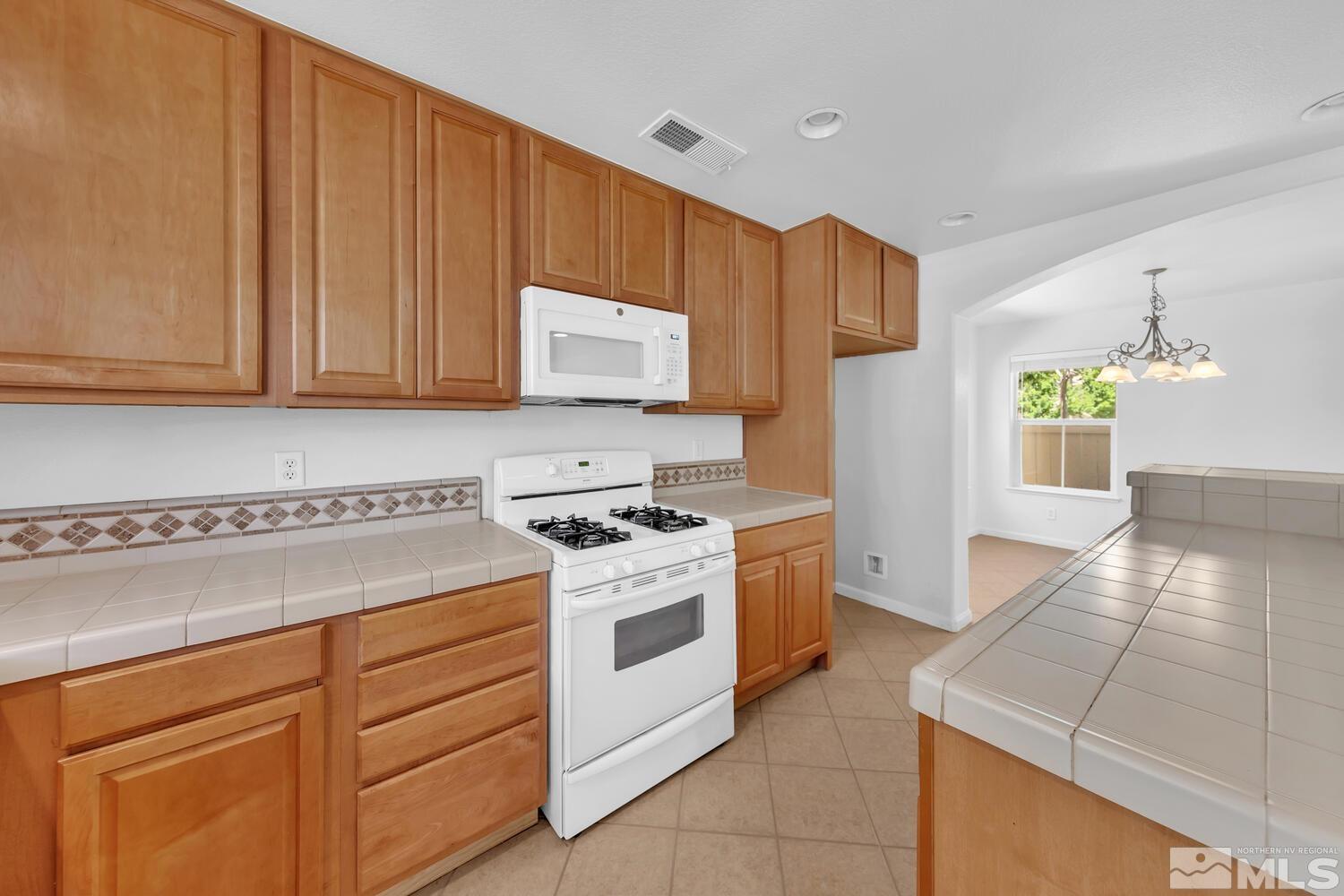 7696 Stone Bluff Way Reno, NV 89523 - Photo 10 of 40 a kitchen with cabinets appliances and a sink