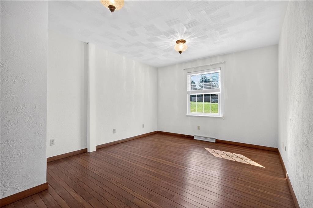 110 Spring Drive Apollo, PA 15613 - Photo 16 of 50 an empty room with wooden floor and windows