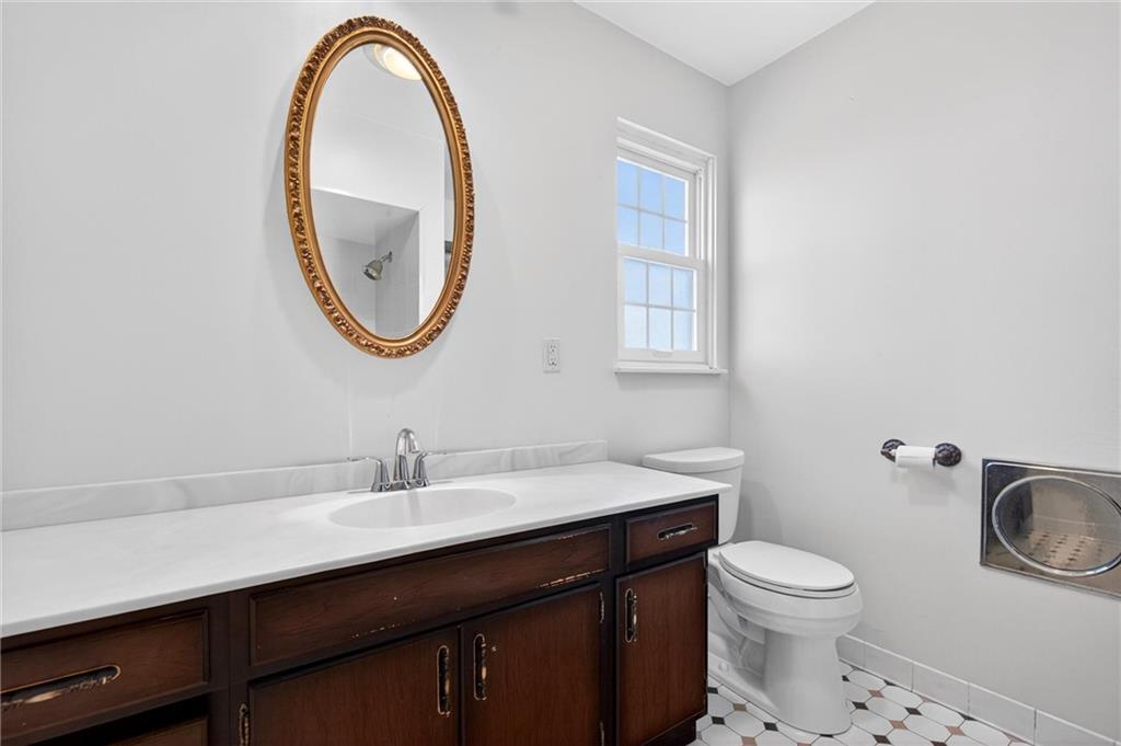 110 Spring Drive Apollo, PA 15613 - Photo 26 of 50 a bathroom with a toilet a sink a mirror and a window